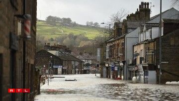 A car is seen submerged as flood water covers the roads in Mytholmroyd, northern England, on February 9, 2020, after the River Calder burst its banks as Storm Ciara swept over the country.