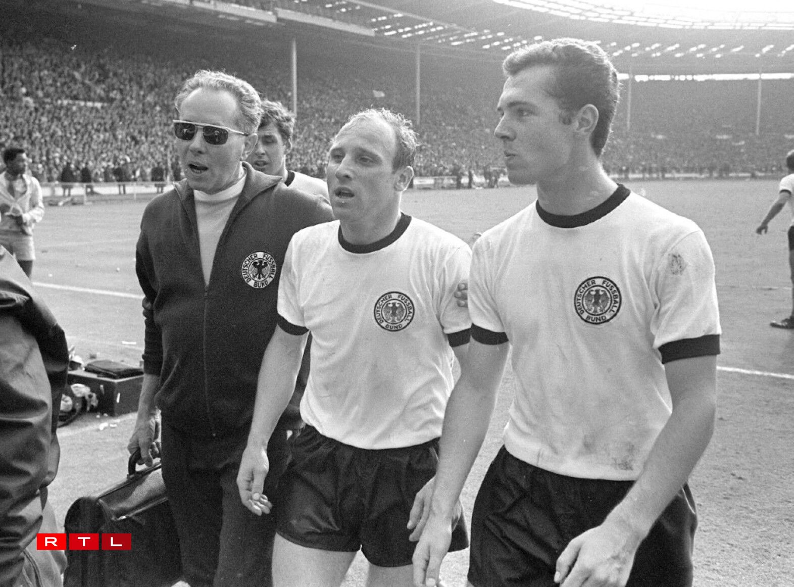 Finale de la Coupe du Monde de football 1966 au stade de Wembley à Londres. L'Angleterre bat la République fédérale d'Allemagne par 4 buts à 3. Les joueurs Uwe Seeler et Franz Beckenbauer (à droite) quittent le terrain.