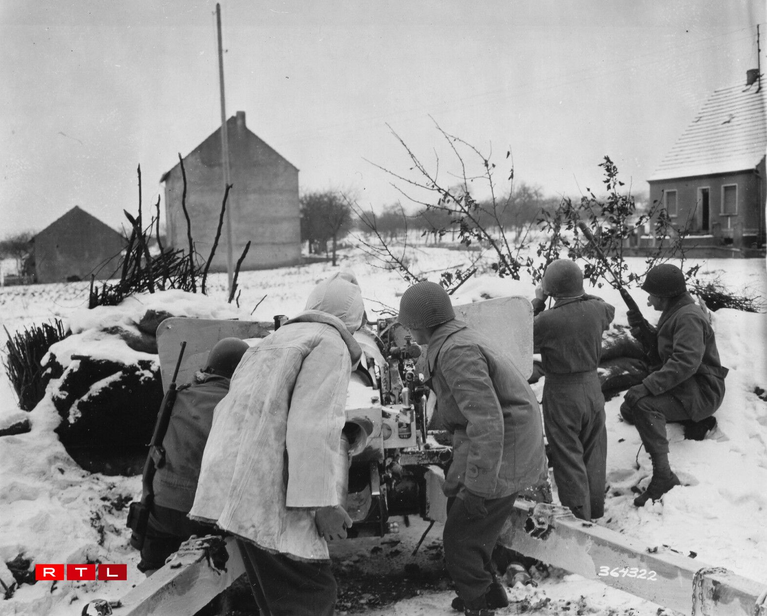 The crew of a three-inch gun covers a front line road on which G-2 has reported 20 German tanks to be advancing. 94th Division sector, junction of France, Germany and Luxembourg. 19 January, 1945.