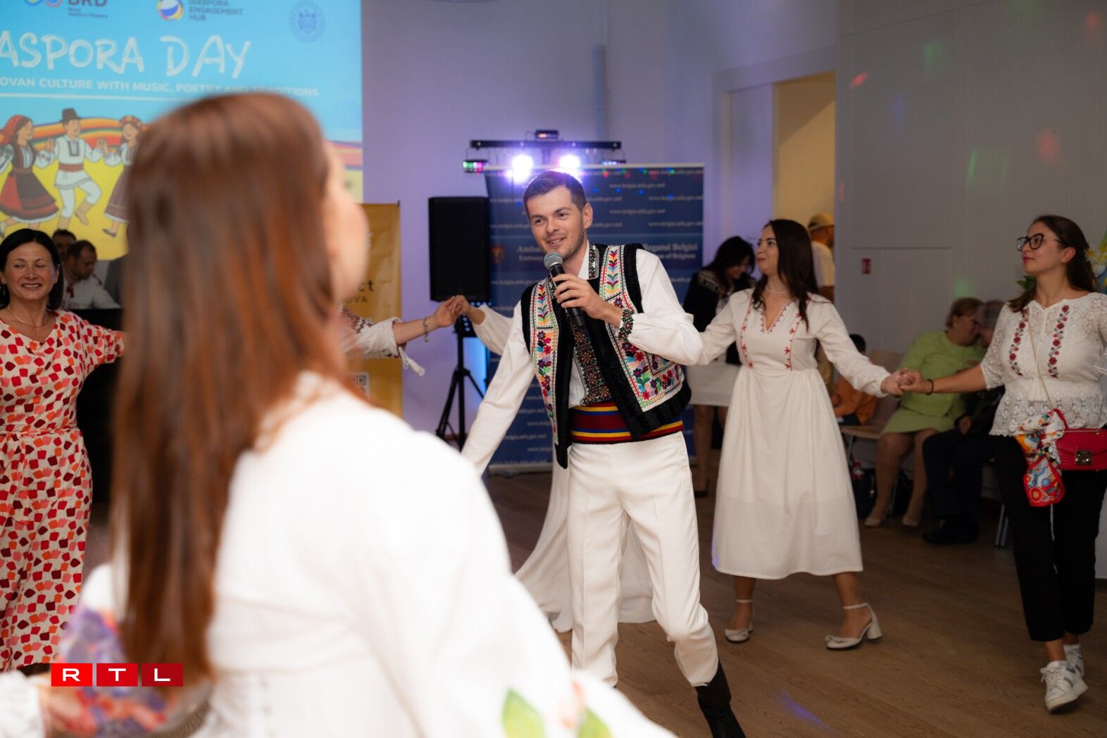 Moldovan singer Damian Spinei, as people join in the traditional Moldovan dance ‘Hora’.