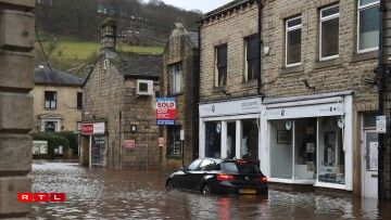 A car is seen submerged as flood water covers the roads in Mytholmroyd, northern England, on February 9, 2020, after the River Calder burst its banks as Storm Ciara swept over the country.