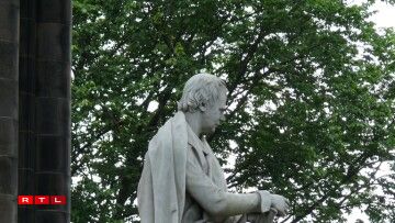 Maida the dog, seen at the side of the sculpture of Sir Walter Scott. The Scott Monument is another of Edinburgh's most prominent buildings.