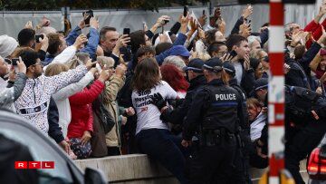 Animal rights activists from PETA, an international charity which defends animal rights, are being escorted away by police officers as they wear shirts reading
