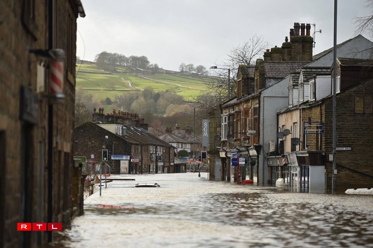 A car is seen submerged as flood water covers the roads in Mytholmroyd, northern England, on February 9, 2020, after the River Calder burst its banks as Storm Ciara swept over the country.
