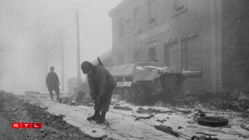 Signalmen of the 17th Airborne Division are laying wire through the town of Marnach, Luxembourg, to an artillery observation post. 31 January, 1945.