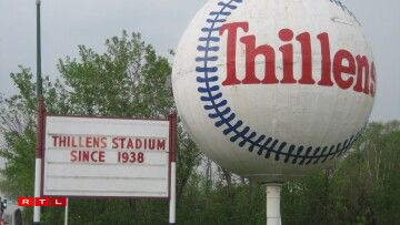 Large Baseball and Sign at Thillens Stadium .