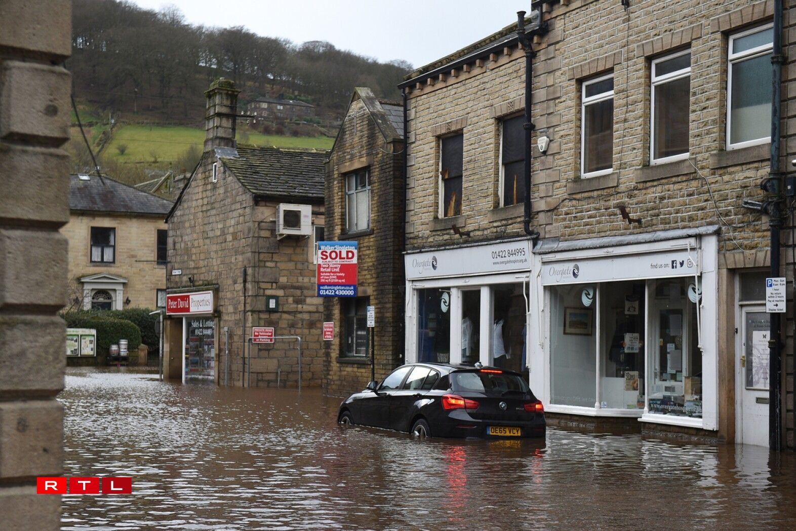 A car is seen submerged as flood water covers the roads in Mytholmroyd, northern England, on February 9, 2020, after the River Calder burst its banks as Storm Ciara swept over the country.