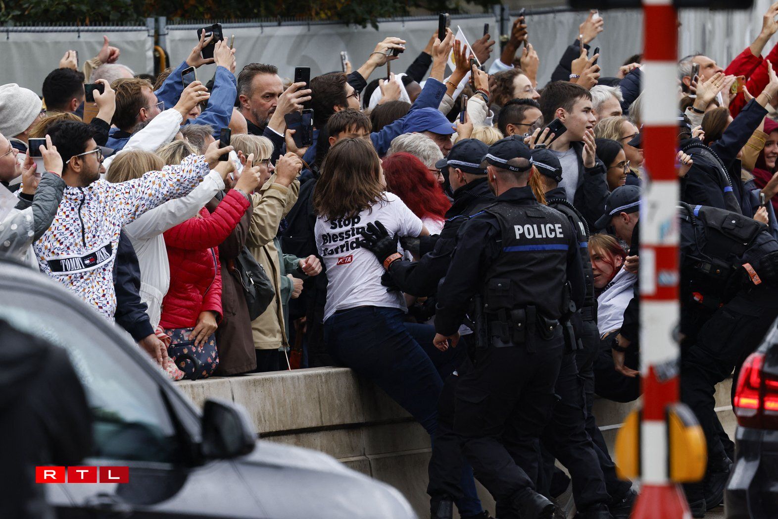 Animal rights activists from PETA, an international charity which defends animal rights, are being escorted away by police officers as they wear shirts reading